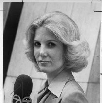 Joan Lunden, holding a microphone, upper body, slight profile