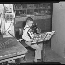 Boy playing an accordian