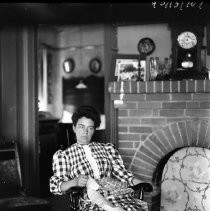 Woman posing in front of fireplace