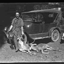 Man with two dead deer