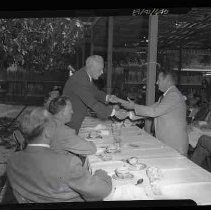 Two men at an outdoor dining table at the State Fair