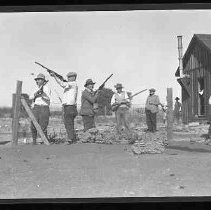 A hunting club posed with guns