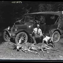 A man with two dead deer