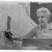 Sema Levinson, director of the Family Service Agency of Sacramento, standing in front of a map of the county