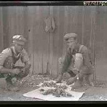 Men with dead game birds