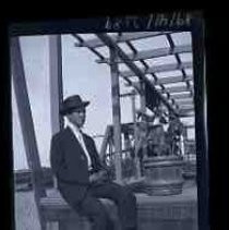 A young man sitting beneath a pergola