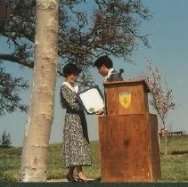 Walerga Park Plaque Dedication: Unidentified Speaker at Podium with Woman