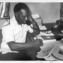 Dr. Walter J. Leonard, attorney and expert on university admissions, on the phone with legal books