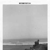 Mouth of Klamath River, Old Requa. Town was on side of hill opposite the rock, 'Aregos.' Mouth of the river is below the rock. '61"