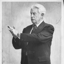 Irving P. Krick, American meteorologist and inventor; 3/4 length portrait in profile with arms outstretched