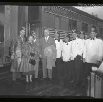 Shriners standing next to a train