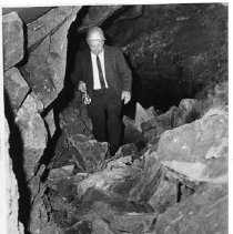 A man with a flashlight inspects a cave near the site of the proposed Auburn Dam