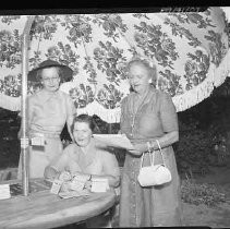 Three unidentified women at patio table