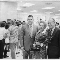 Unidentified woman and two unidentified men posing for photo following ribbon-cutting ceremony at J. C. Penney store