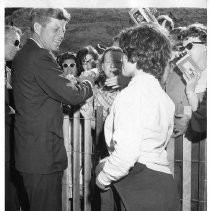 John F. Kennedy, shaking hands with people in a crowd