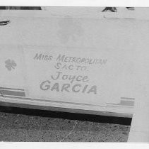 Joyce Garcia, Miss Metropolitan Sacramento, sign on car in which she was seated for parade