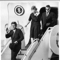 President John F. Kennedy arriving on Air Force One in Redding, waving