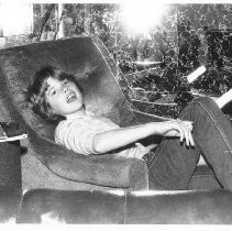 Young unknown boy sitting in chair