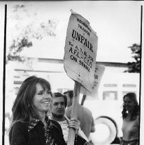 Jane Fonda carrying picket sign