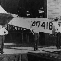 Probably Liberty Iron Works' workers posing in front of plane