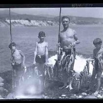 Man and boys fishing on a river