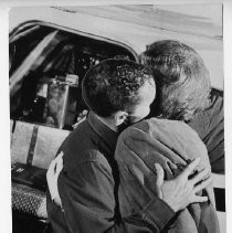 Dr. Alvin Marks, pilot and owner of Skymark Airlines, embraces his wife Phoebe before leaving