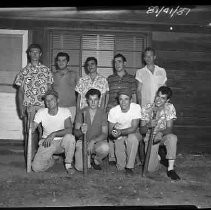 A group of nine teen aged boys holding baseball bats