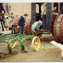 Photographs from Sacramento History Museum Groundbreaking. Plowing attachment being hooked up to antique Case tractor