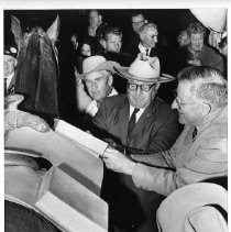 Ernest Reycraft, Waddell Smith, and Federal Judge Sherrill Halbert make sure the pouches are secure for the Pony Express run