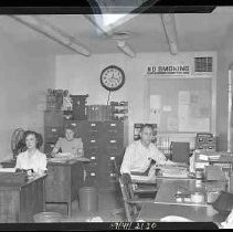 A small office with two women and one man