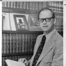 Judge Rothwell B. Mason, Municipal Court Judge, in his office, standing in front of law books