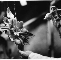 Kent Scheer spays the final coat of white paint to a cast iron ornament for the California State Capitol building