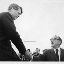 Senator Robert F. Kennedy (D-NY) arriving at airport in Sacramento, shaking hands with Governor Pat Brown