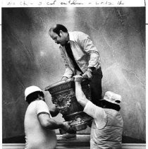 Caption reads" "Urns for the Capitol" Instaling one of four classical-style urns in the rotunda of the renovated California State Capitol building are from the left, Willie Valario, Mike Abshear and Ernie Valdez