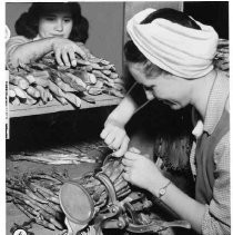 View of two cannery workers preparing asparagus for canning