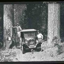 Three men and a car in the mountains