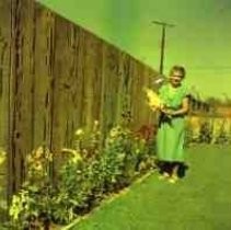 A woman standing in a flower bed