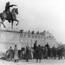 Soldiers standing at the base of a statue