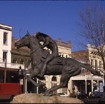 Old Sacramento. View of the Pony Express Statue site at 2nd and J Streets. View shows the site and installation of the statue. Crowd gathers during dedication