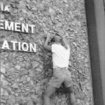 Woman Climbs Wall