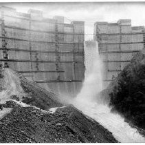 Water spills over a low section of the Bullards Bar Dam