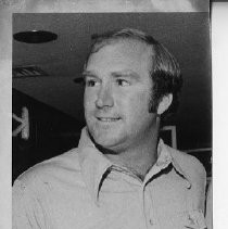 Bob Lunn, pro golfer, smiles as he looks to his right