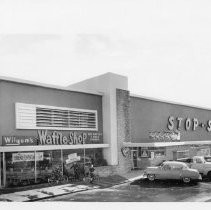 Exterior view of the Stop N Shop grocery store owned by the Kassis family. This store was on Stockton Blvd. in Sacramento. To the left is Wilyum's Waffle Shop restaurant