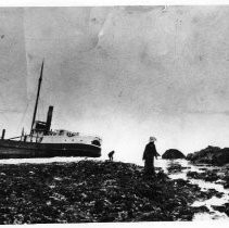 Photographs of landscape of Bolinas Bay. Photo of a ship run aground with two people nearby