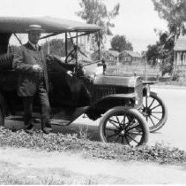 Man standing front of automobile