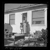 A woman and a boy standing on steps