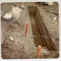 Photographs of landscape of Bolinas Bay. Open trench, dig site with tools, stakes and marking strings