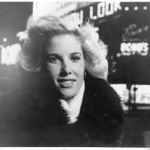 Joan Lunden in New York City with neon signs in background