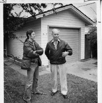 Harry Johnson, right, explains how he lowered his rents in front of house on 519 Campus Blvd. he rents to Kris Fairbrother, a UCD student, left