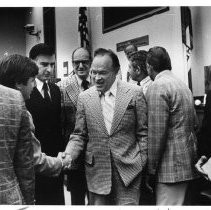 Bob Hope, the legendary comedian and movie and TV star, greeted legislators after he received plaque, held in photo by sgt. at arms. Gov. Jerry Brown is next to him (left)